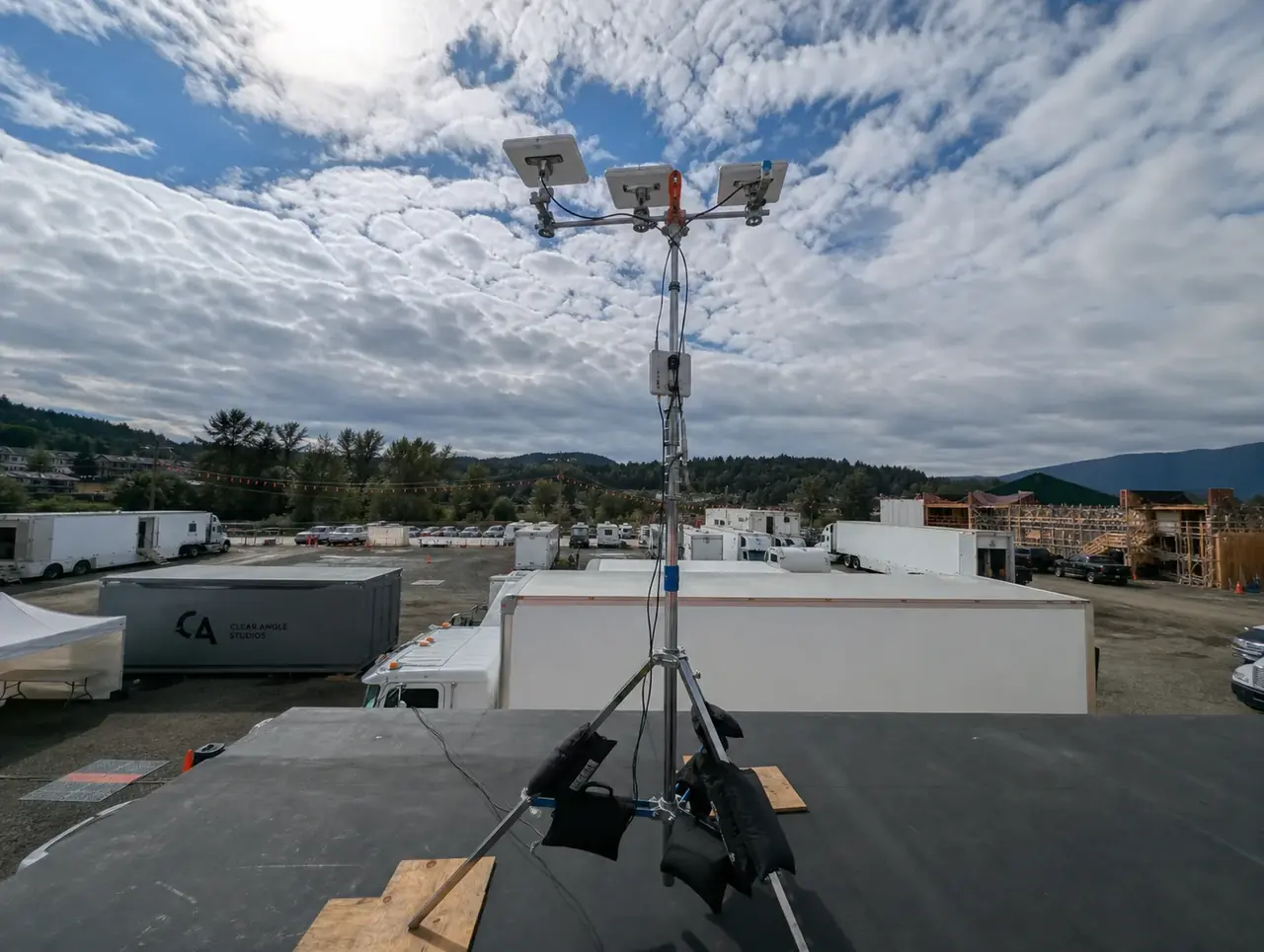 Canary Uplink three-Starlink mast overlooking a production lot